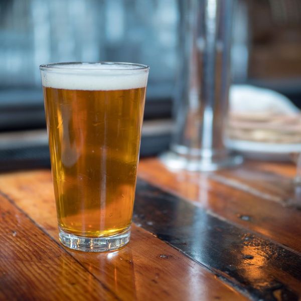 pint glass on counter filled with beer