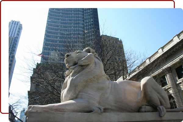 a stone lion in front of a building Home.png