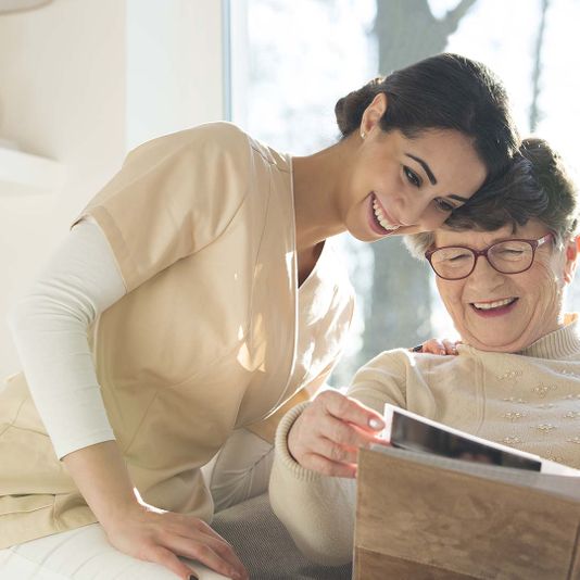 Nurse and senior smiling together