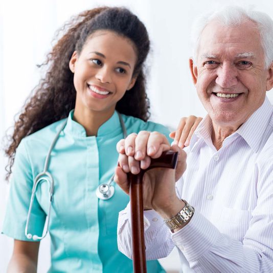 Nurse and senior smiling