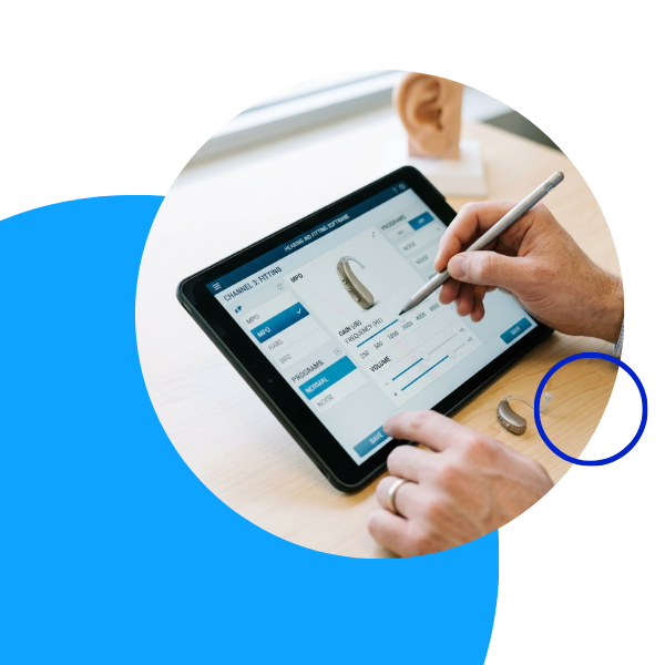 Hands adjusting a small electronic device using a tablet interface.