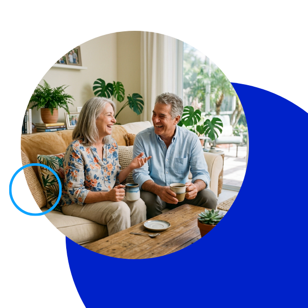 Happy mature couple laughing and enjoying a clear conversation over coffee.