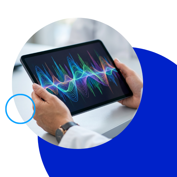 Close-up of hands holding a tablet showing colorful diagnostic sound wave graphs.