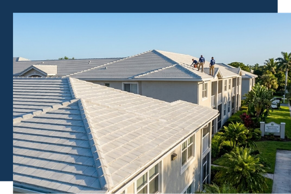 Workers on top of a roof of multi-family property
