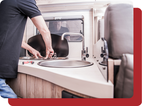 tech fixing the sink in a camper