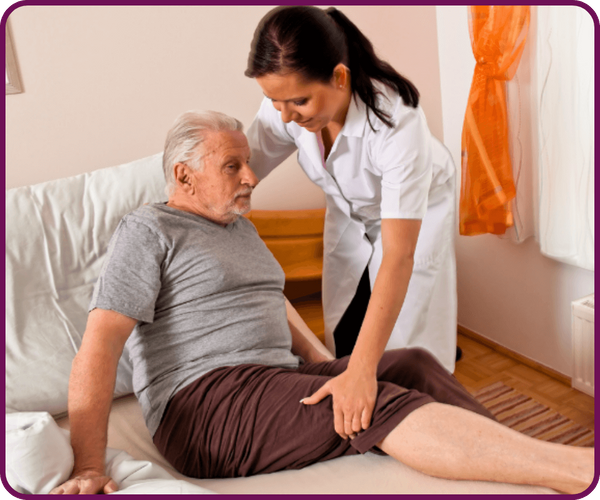 Image of a caregiver helping a man back into bed