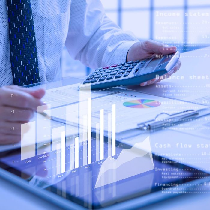 Graph overlay on top of a tablet and financial documents.