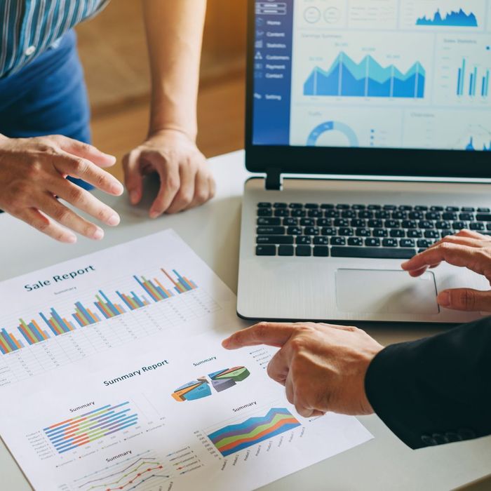 Two people analyzing financial documents. 