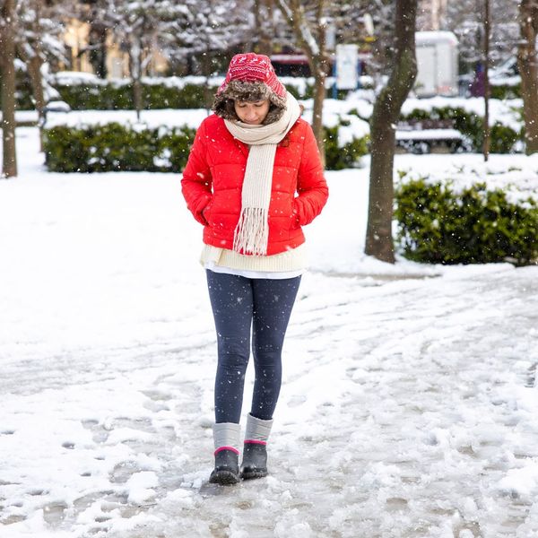 Woman walking on icy sidewalk