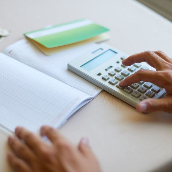 A person reviewing a financial document, symbolizing the cost-effectiveness of hydroseeding.