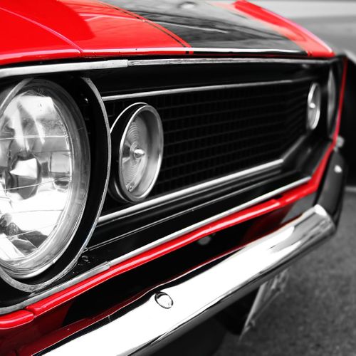 Front of a classic red car. 