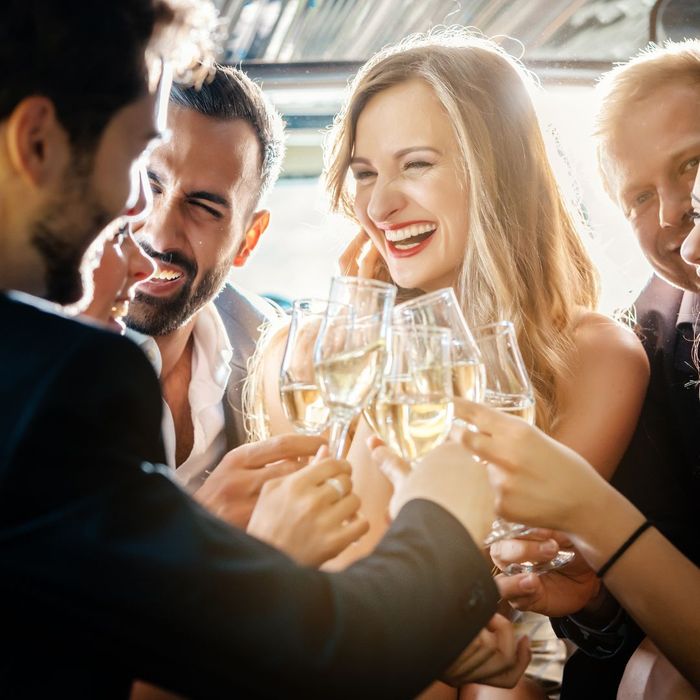 group of friends cheering wine glasses