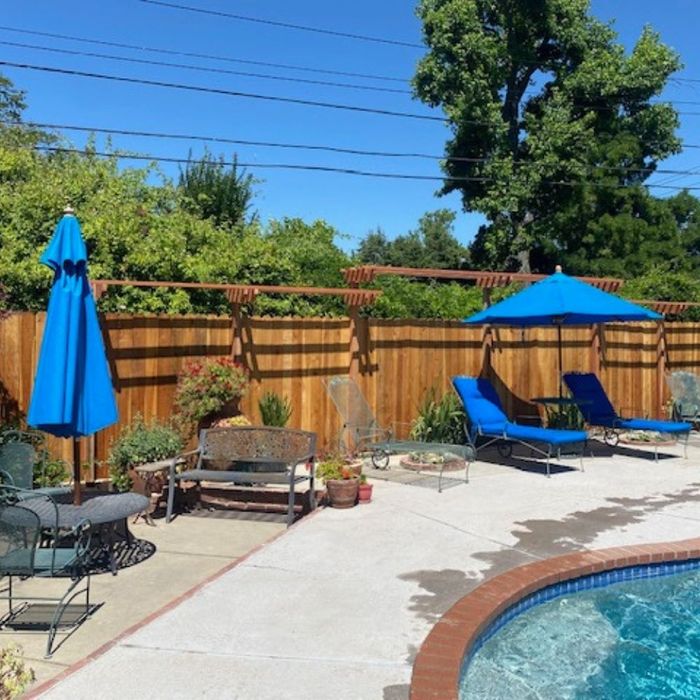 A large yard with fence and pool