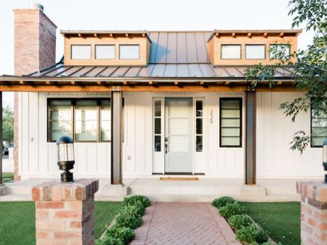 The front of a nice modern home with a pathway leading to the door