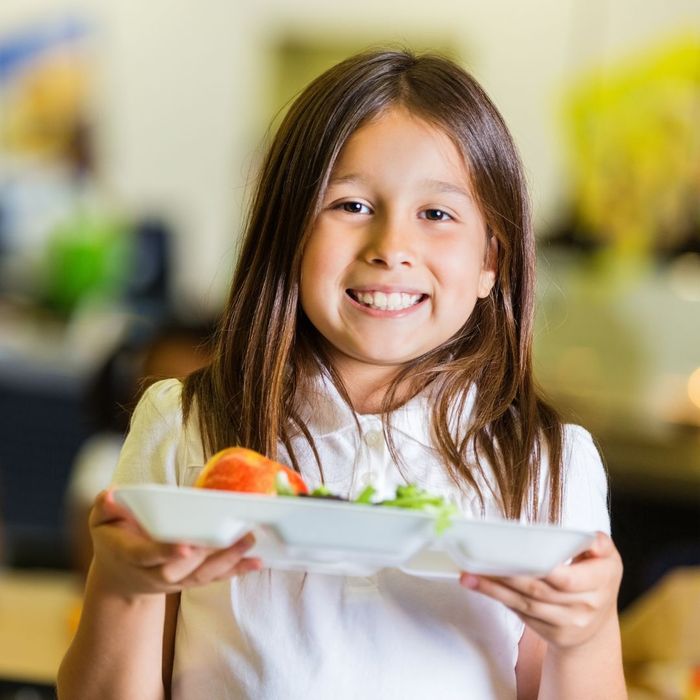 young girl with school lunch