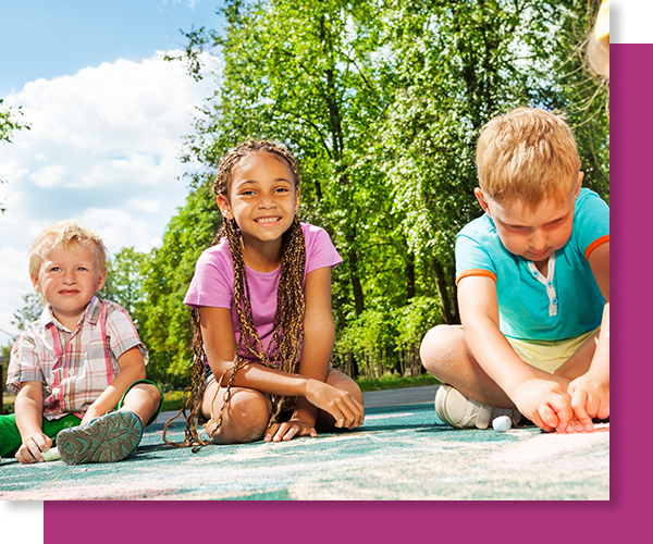 smiling kids playing with sidewalk chalk