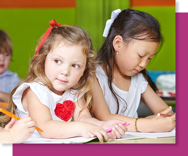 two girls working in work books