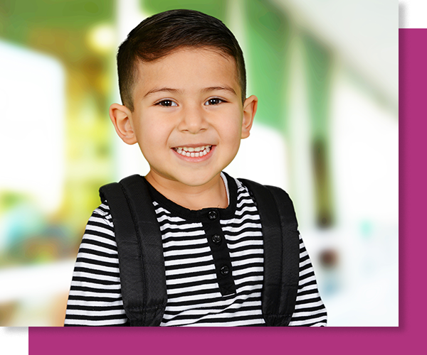 smiling boy wearing a backpack