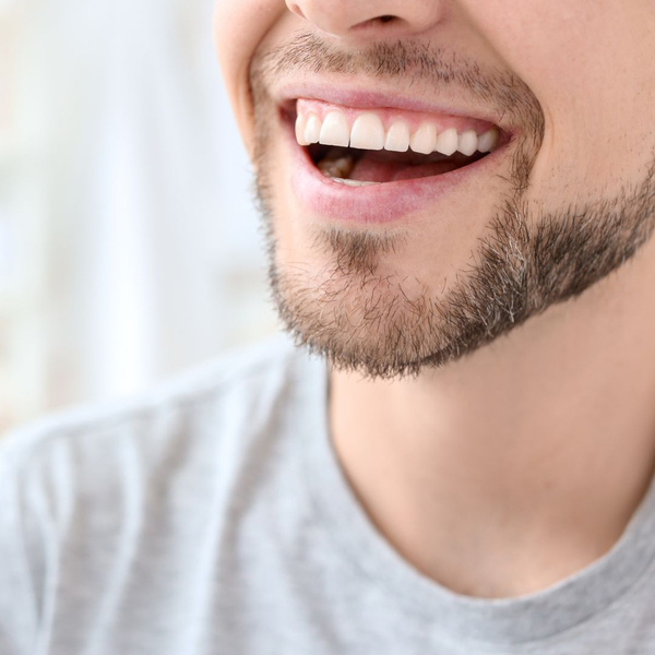 close-up on man's happy smile, straight teeth