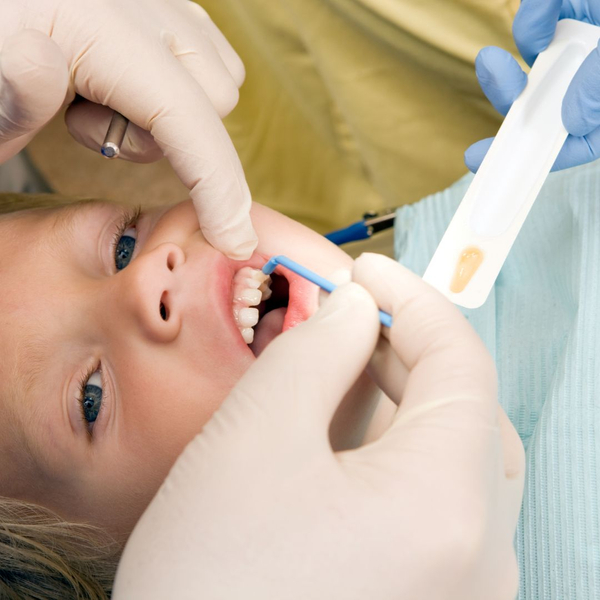 boy receiving fluoride treatment