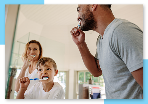 a family brushing teeth
