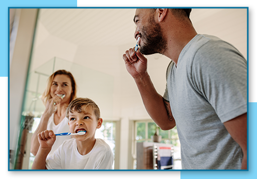 Family brushing teeth together