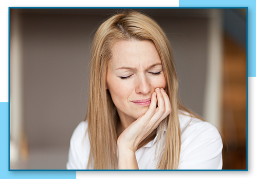 Woman holding her mouth in pain