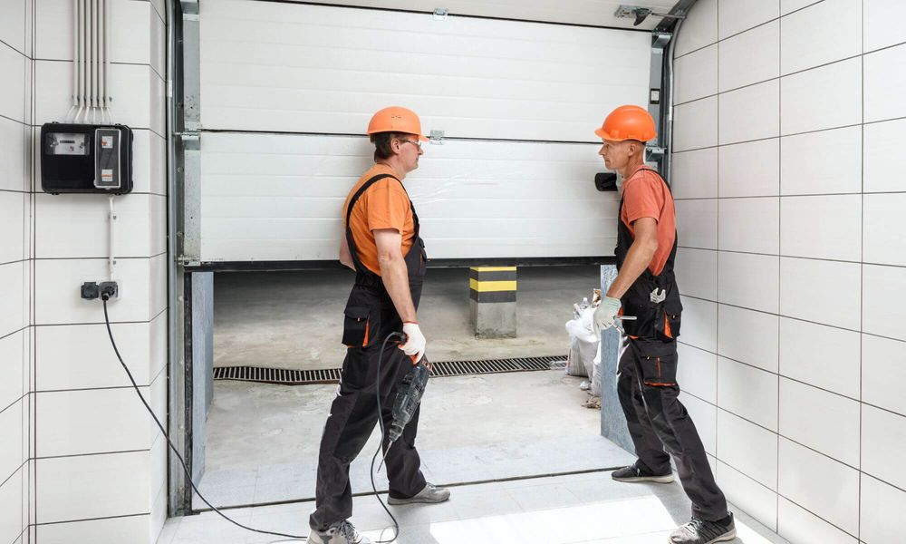two men in hard hats opening commercial garage door