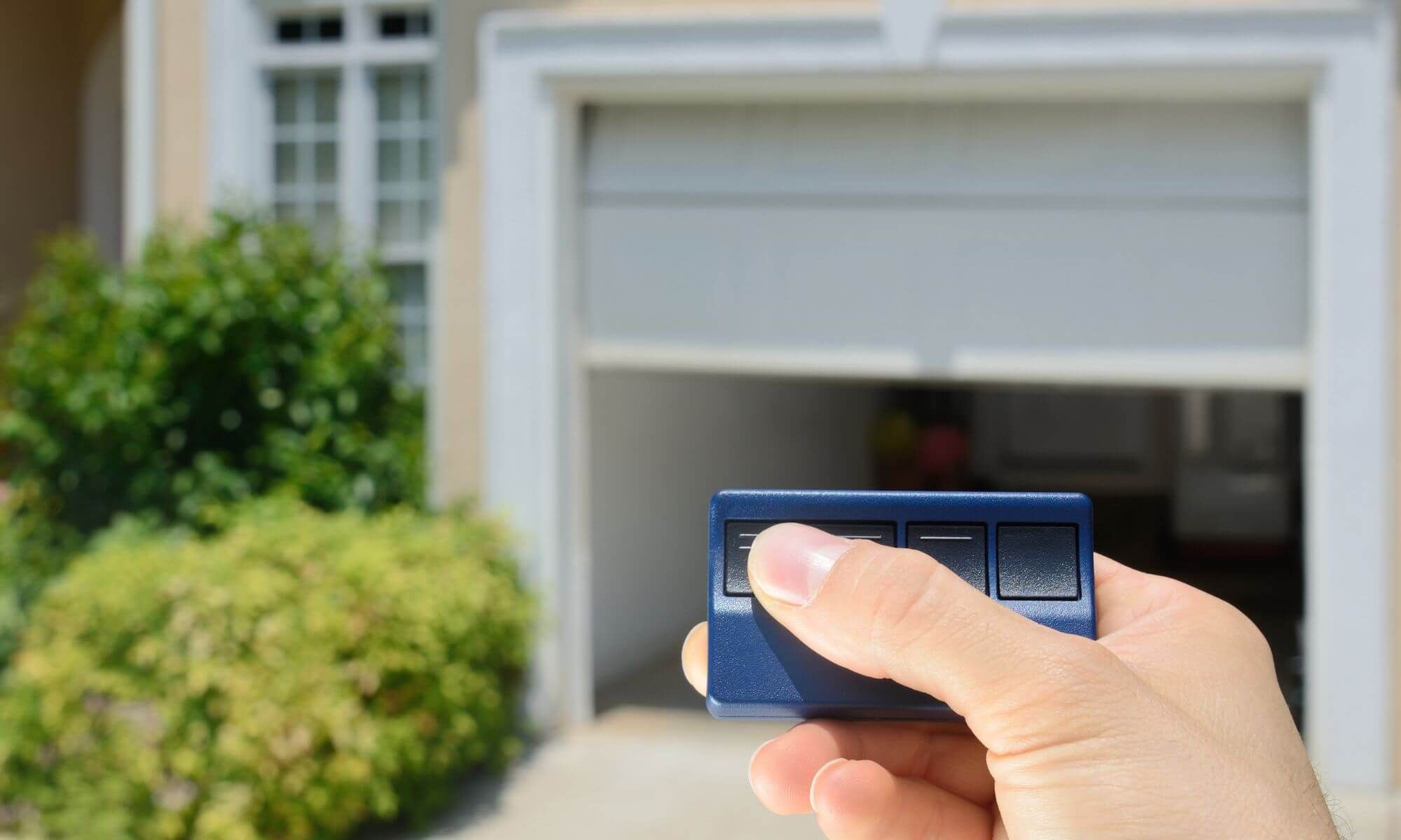 person opening garage with remote