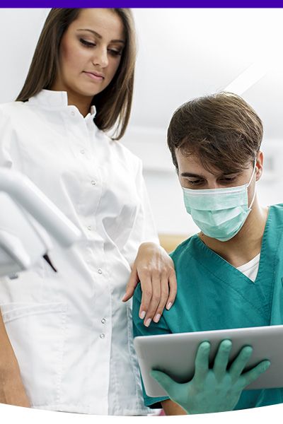 Image of a dentist training a dental tech