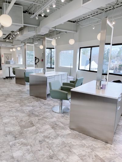 Bright and modern interior of Alexander Hair Creatives in Derry NH, featuring sleek styling stations, natural light, and a relaxing, professional atmosphere that defines the AHC guest experience. Alexander Hair Creatives Salon Interior Derry NH