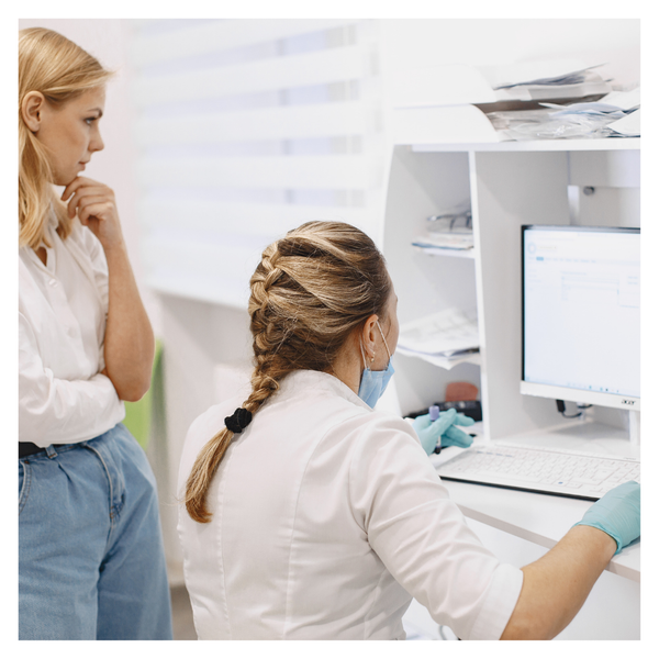 Doctor looks at data on a computer screen