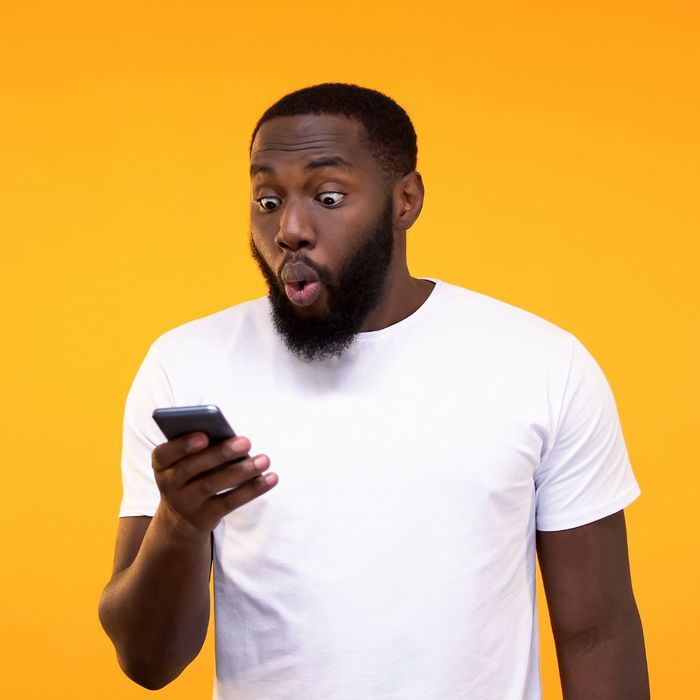 excited man looking at phone excited man looking at the phone