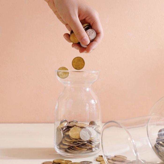 putting coins into a jar putting coins into a jar