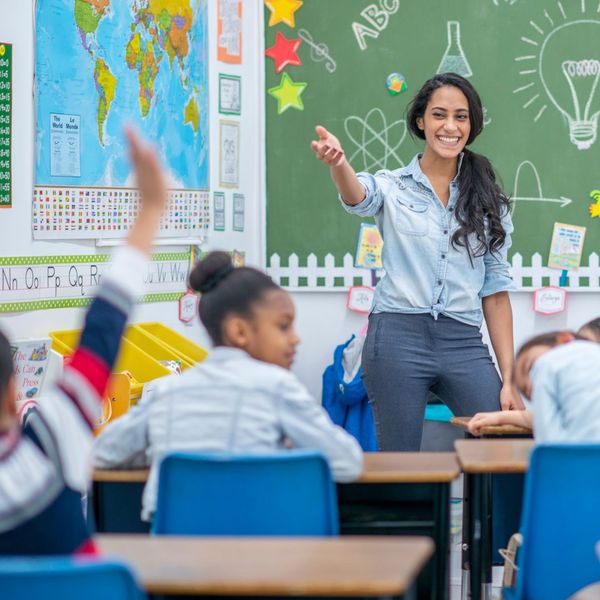 teacher calling on student with raised hand