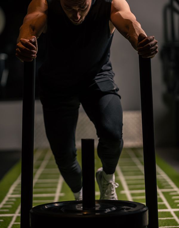 Man pushing sled crossfit