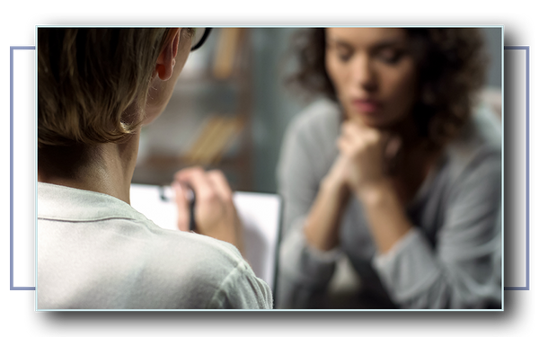 Young women talking to counselor during a session. 