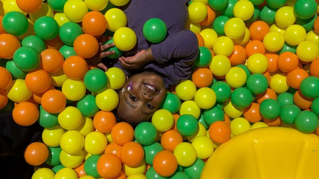 girl in ball pit Grand Opening of Our Second Amherst Daycare Location.jpg