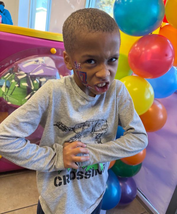kid holds hands together with face paint on cheek Screenshot 2025-04-18 at 3.23.40%E2%80%AFPM.jpeg
