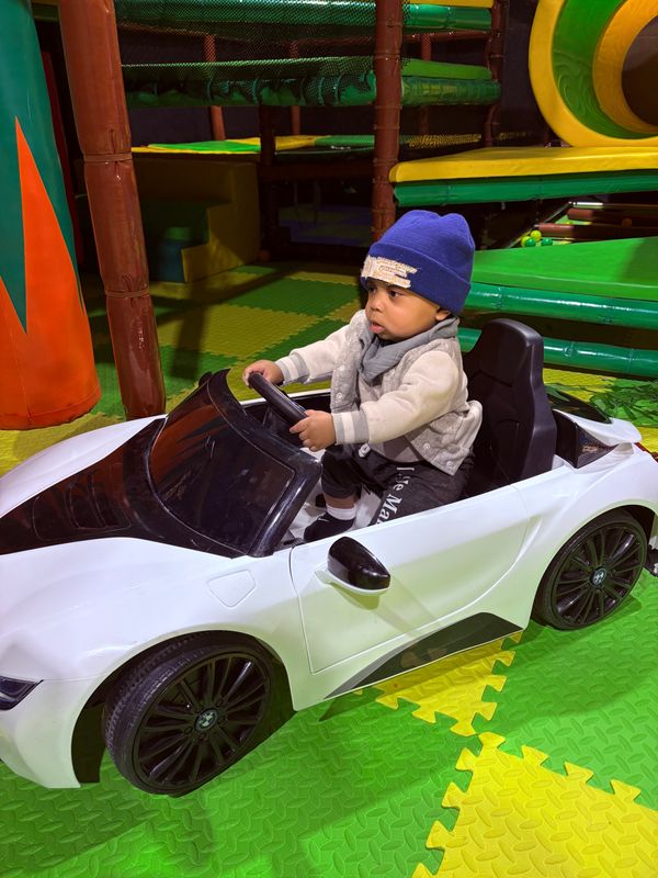 kid in toy car FullSizeRender.jpeg