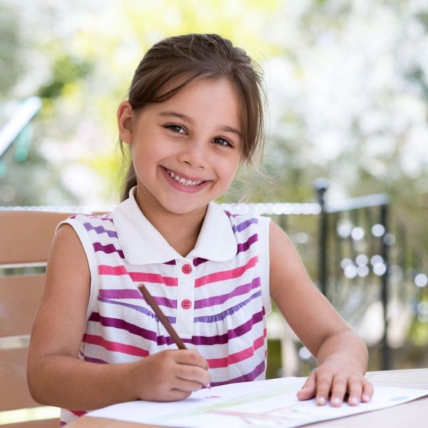 happy girl drawing with colored pencil happy girl drawing with colored pencil