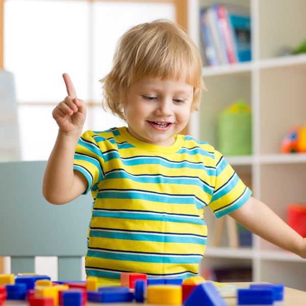happy toddler playing with toys at daycare happy toddler playing with toys at daycare
