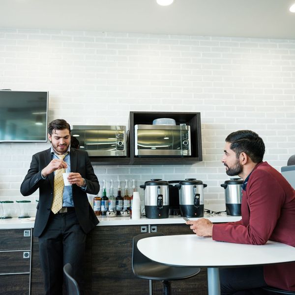 two men talking in a break room