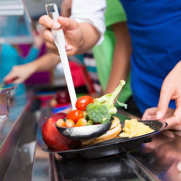 students grabbing a plate of vegetables