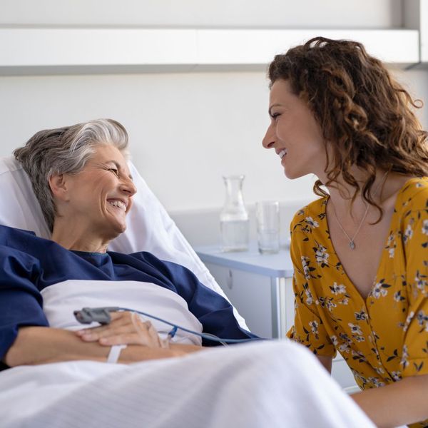 a woman visiting another woman in the hospital