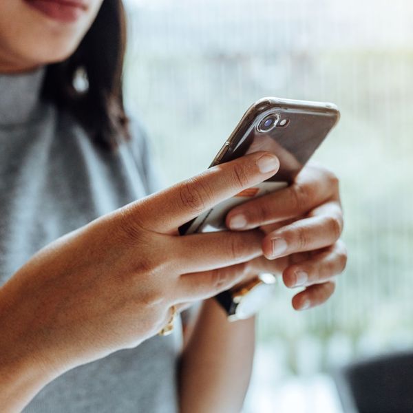 woman looking at their cell phone