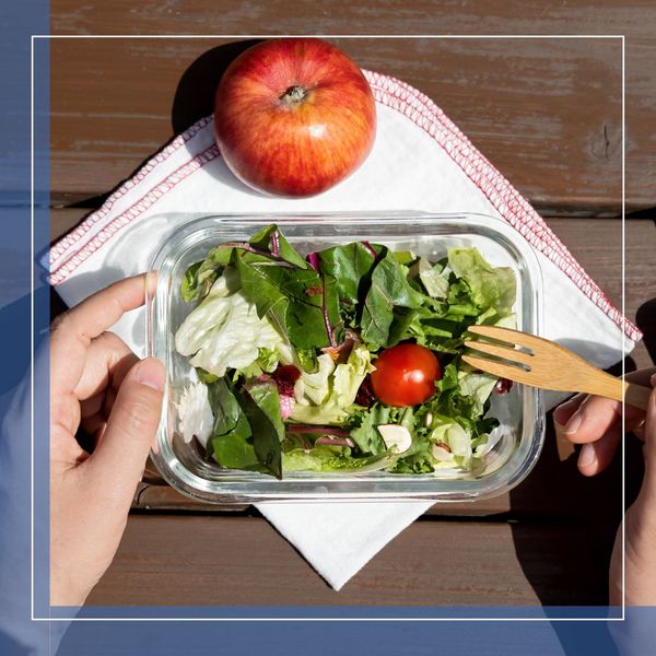 a person eating a salad and apple