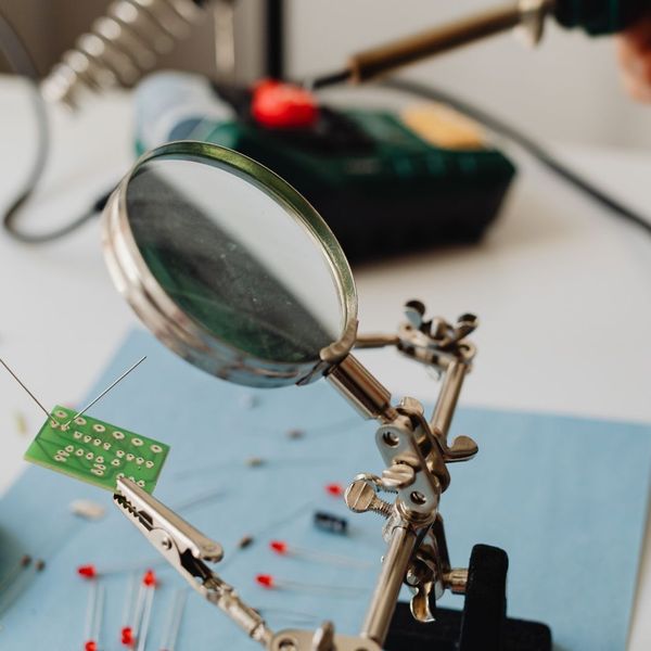 using magnifying glass to inspect