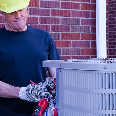 An image of a technician performing HVAC maintenance