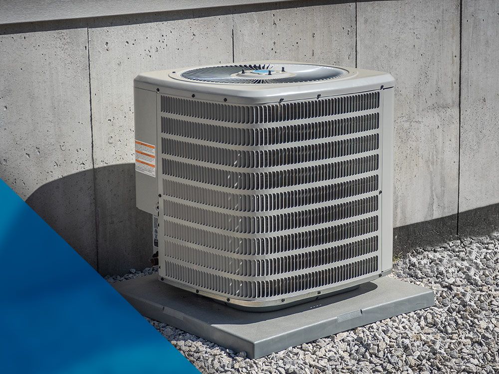 A free-standing air conditioning unit next to a concrete wall